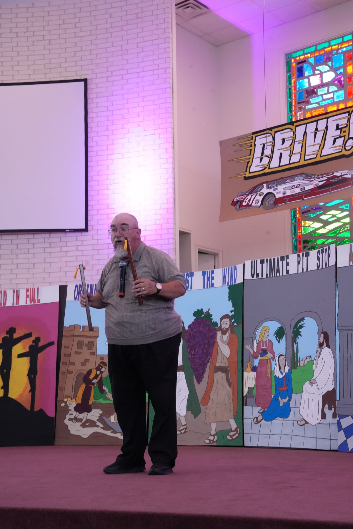 Ken Sibley presenting a Gospel illusion on stage at a Vacation Bible School