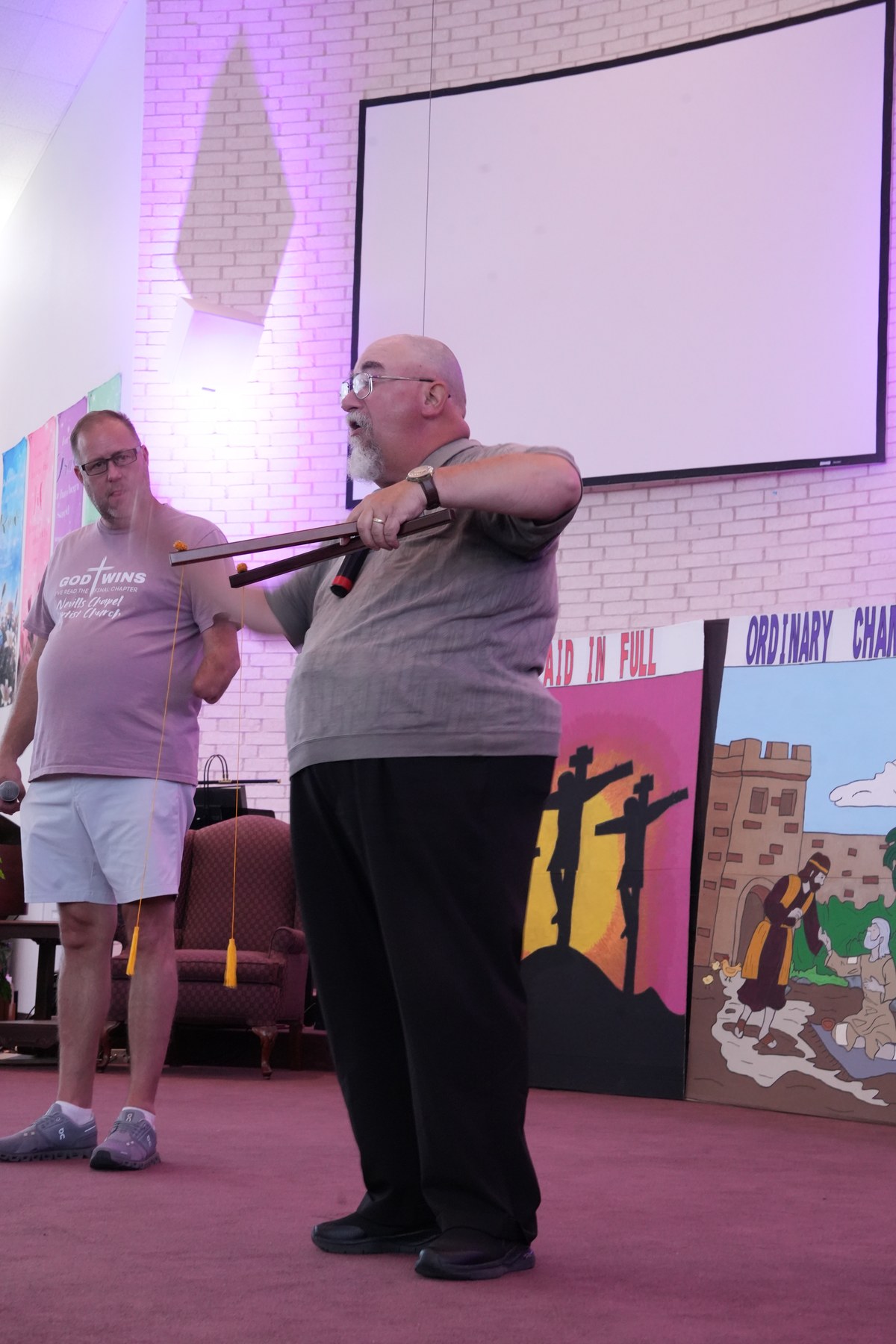 Ken Sibley on stage with a prop during a Gospel illusion